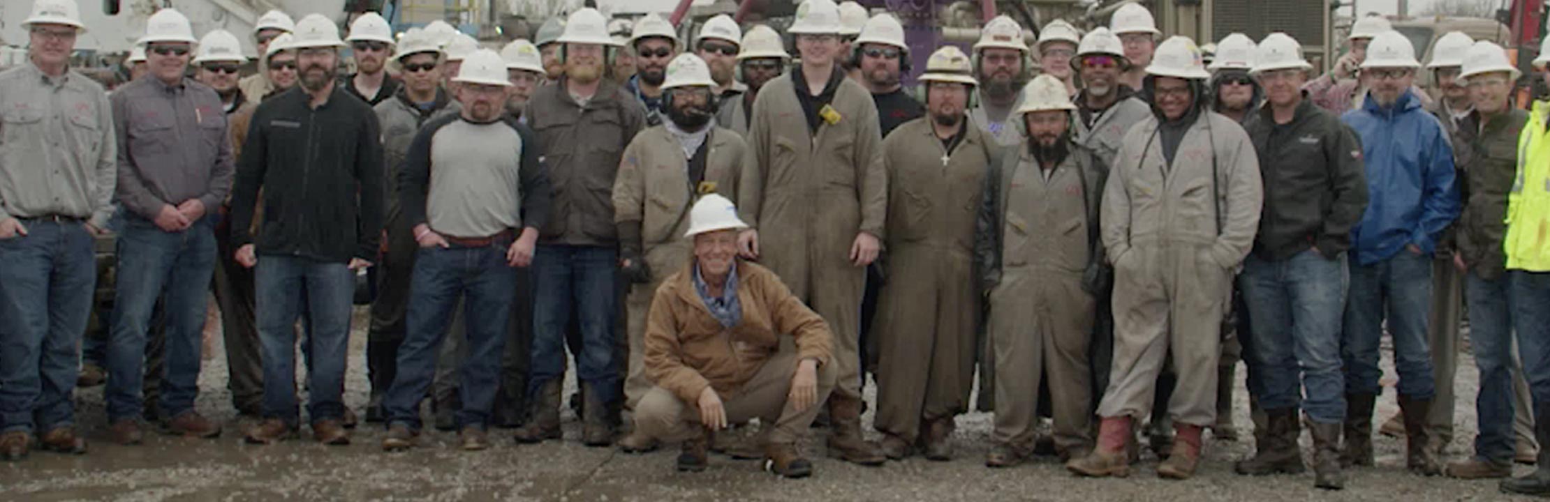 Mike Rowe and oil and gas workers group shot
